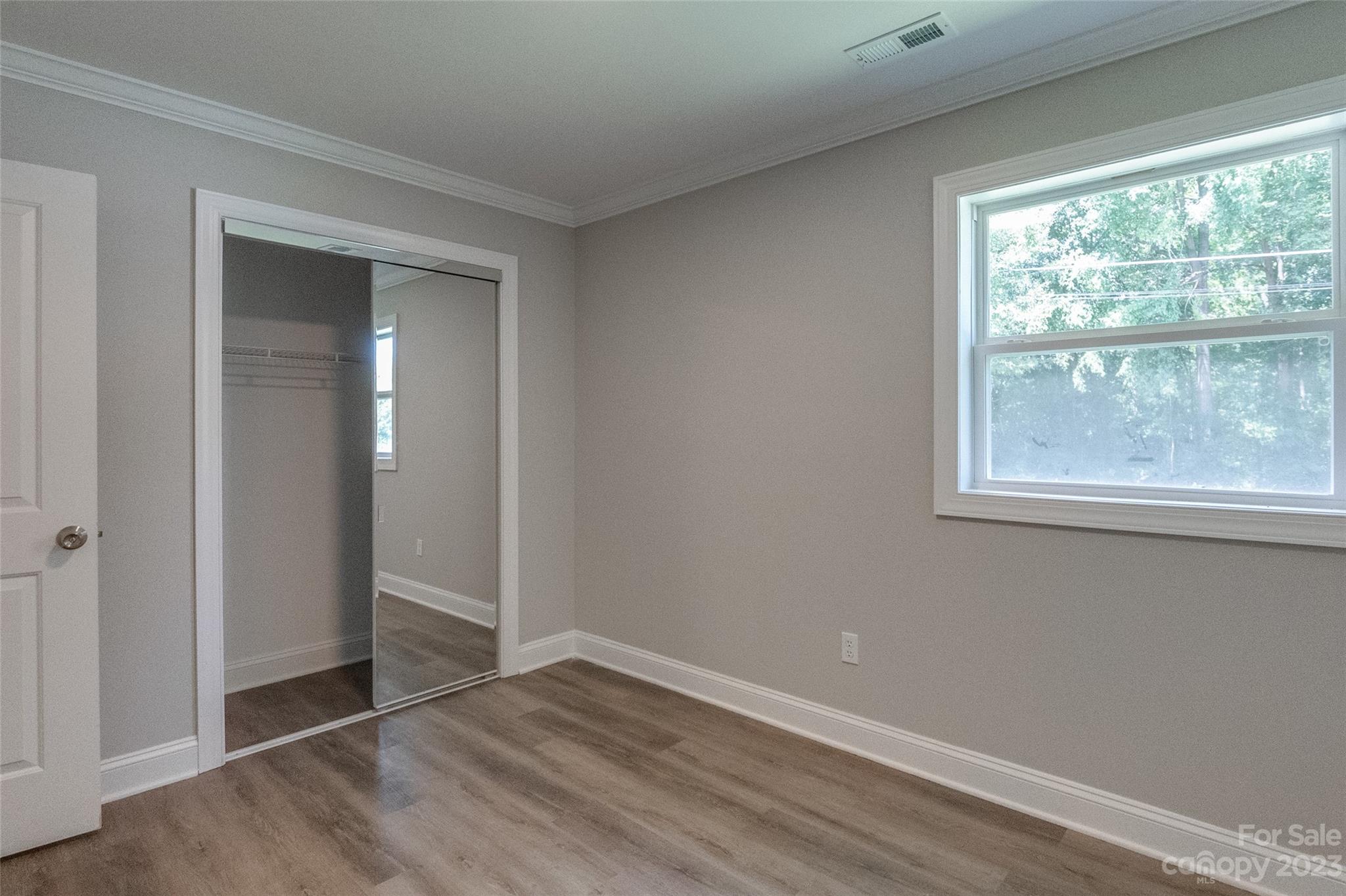 1531 Ruth Street, Unit 2 Lancaster, SC 29720 - Photo 16 of 33 an empty room with wooden floor and windows