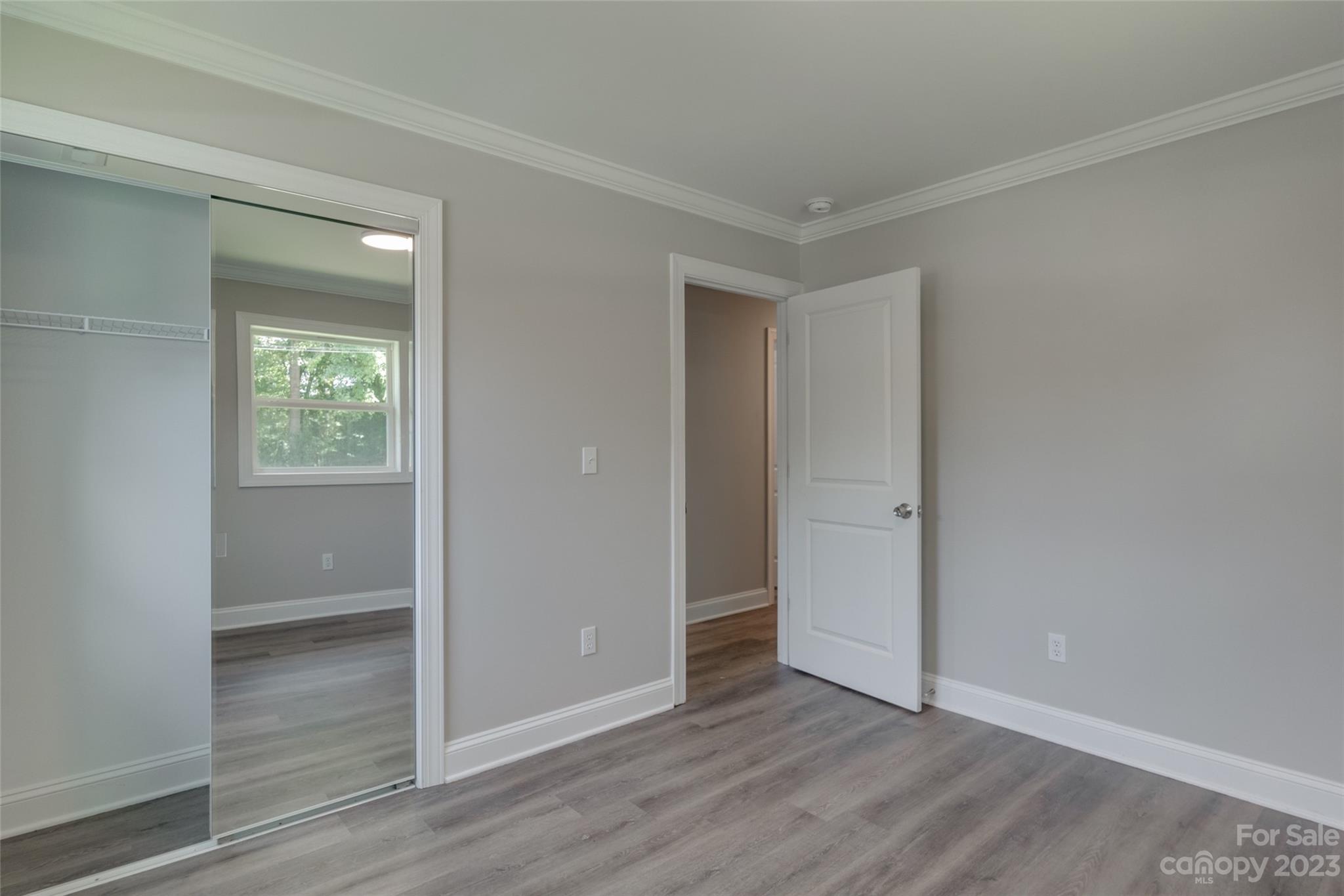 1531 Ruth Street, Unit 2 Lancaster, SC 29720 - Photo 18 of 33 an empty room with wooden floor closet and windows