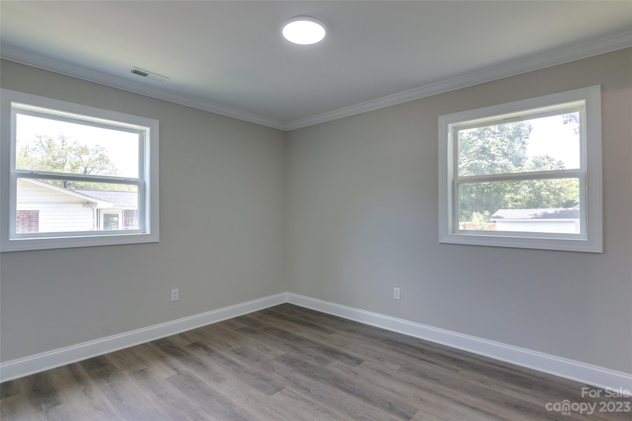 1531 Ruth Street, Unit 2 Lancaster, SC 29720 - Photo 19 of 33 an empty room with wooden floor and windows