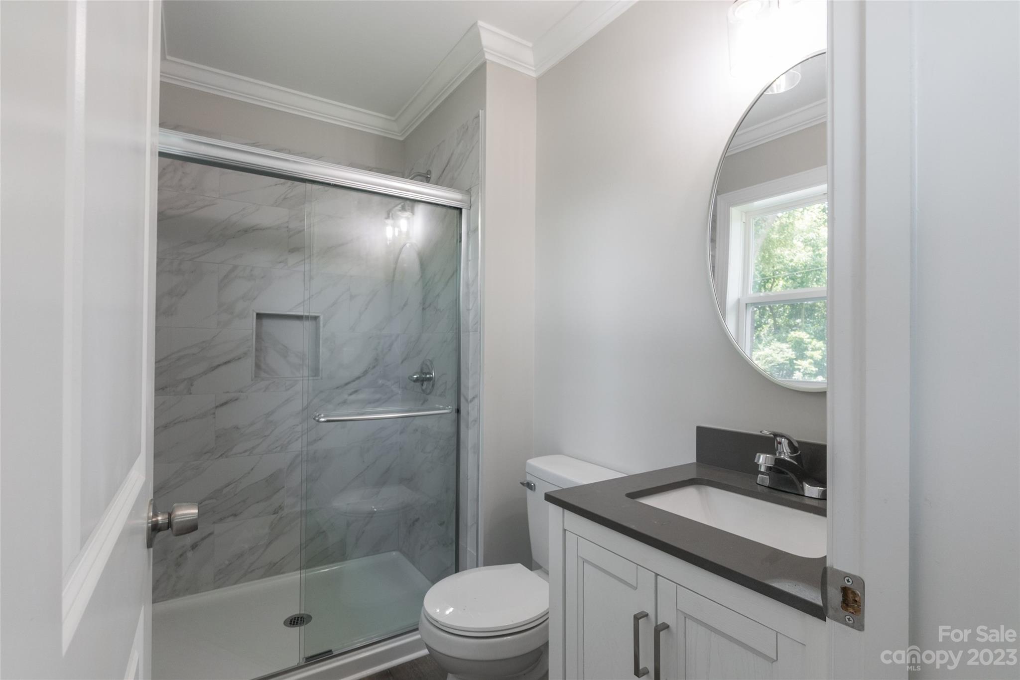 1531 Ruth Street, Unit 2 Lancaster, SC 29720 - Photo 24 of 33 a bathroom with a sink toilet a mirror and shower