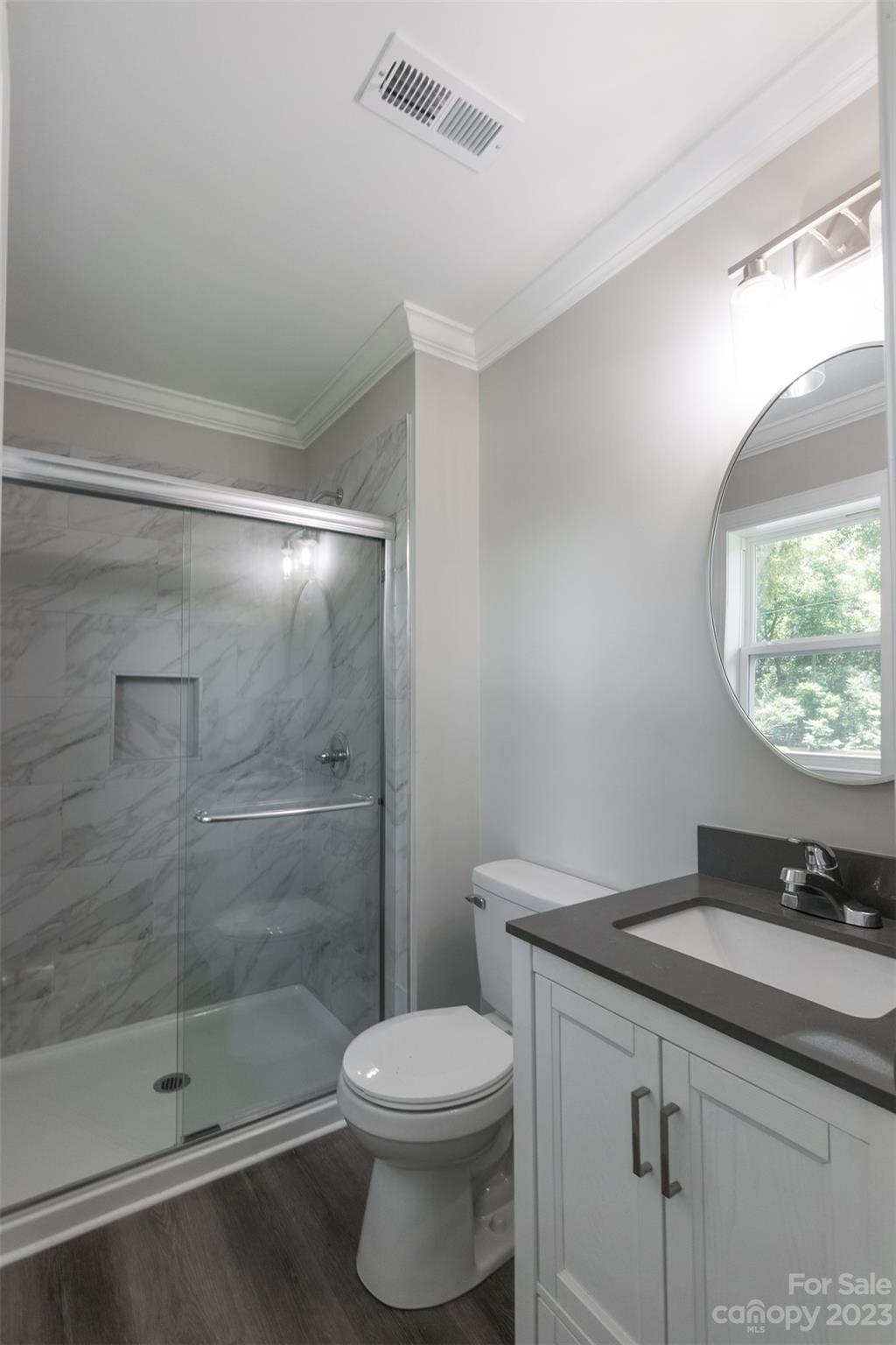 1531 Ruth Street, Unit 2 Lancaster, SC 29720 - Photo 25 of 33 a bathroom with a granite countertop sink a toilet a mirror and shower