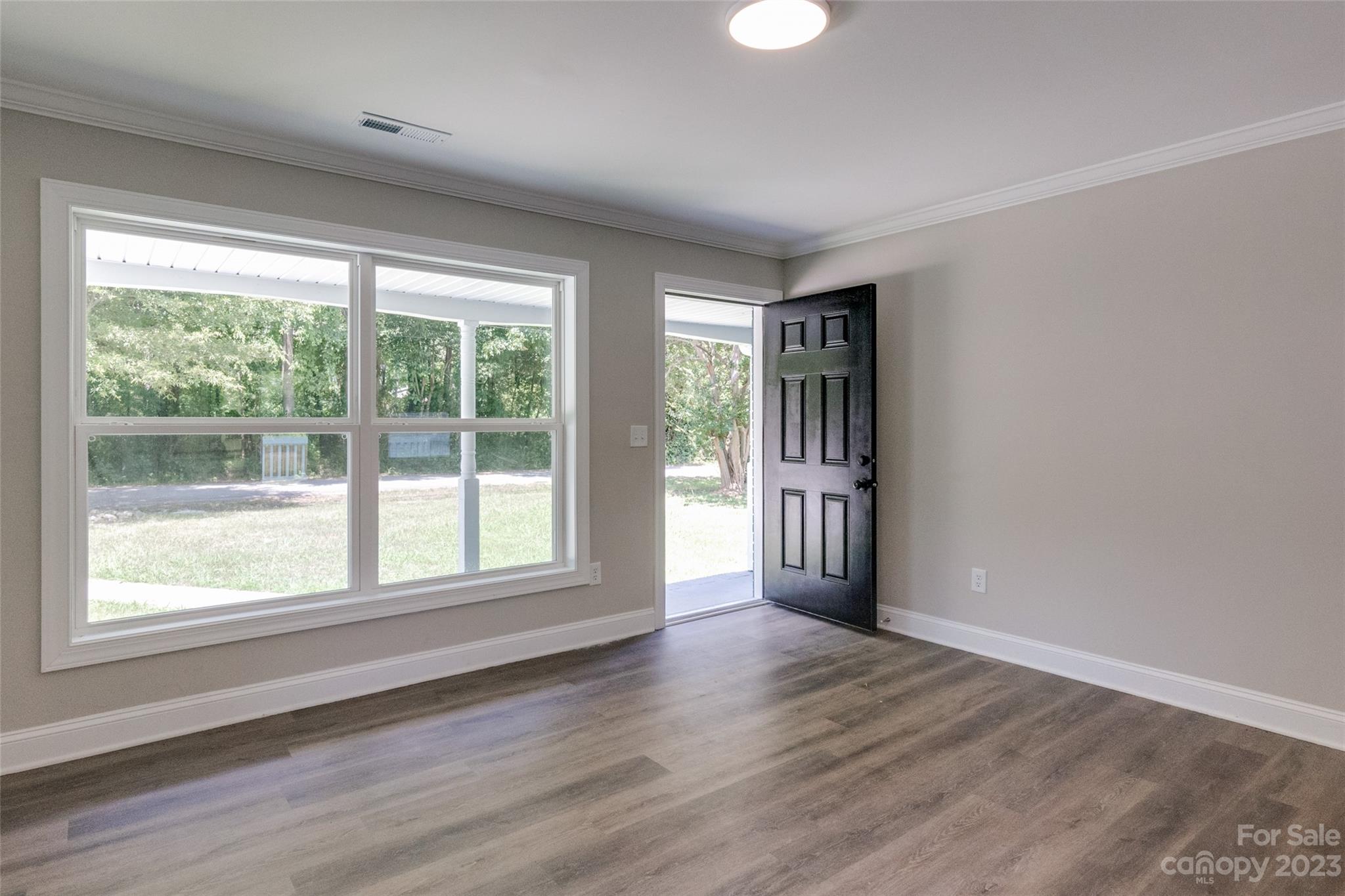 1531 Ruth Street, Unit 2 Lancaster, SC 29720 - Photo 5 of 33 a view of an empty room with wooden floor and a window