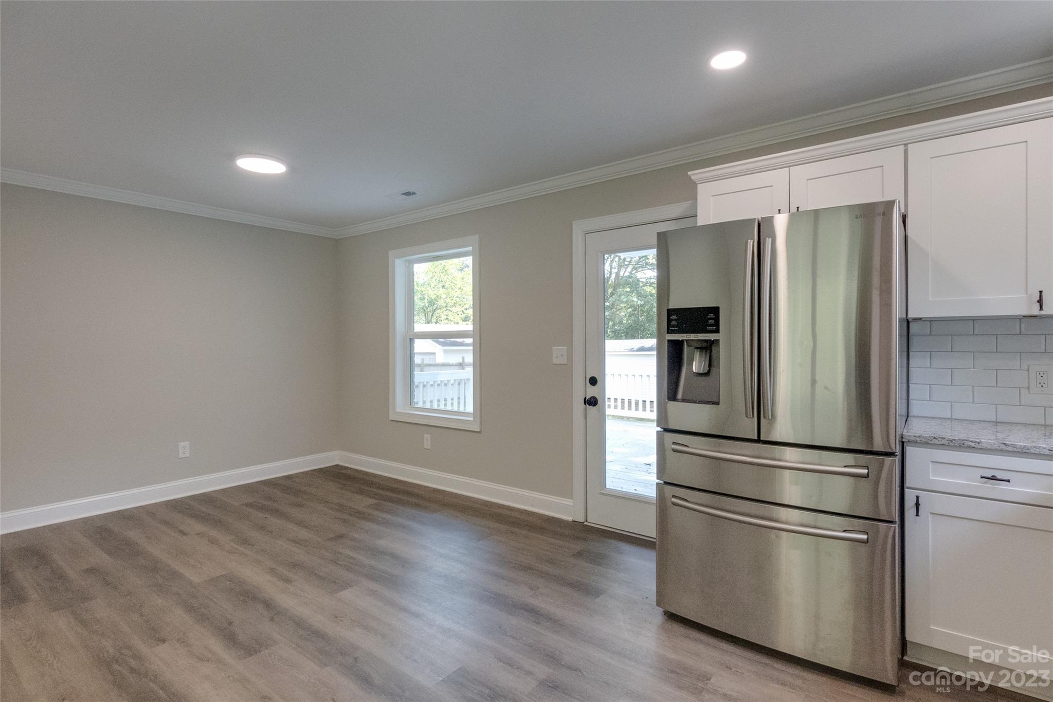 1531 Ruth Street, Unit 2 Lancaster, SC 29720 - Photo 8 of 33 a kitchen with stainless steel appliances wooden floor and window