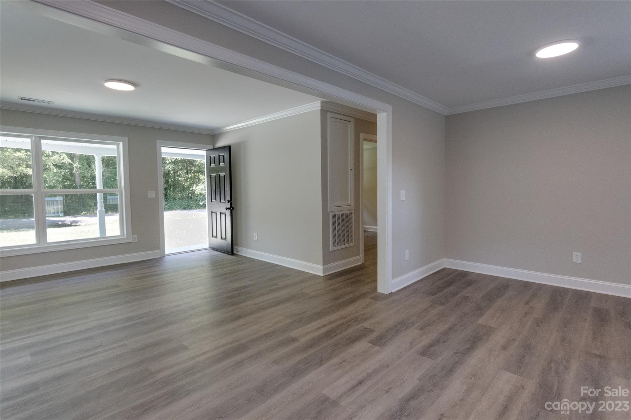 1531 Ruth Street, Unit 2 Lancaster, SC 29720 - Photo 9 of 33 a view of an empty room with wooden floor and a window