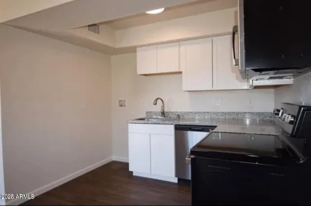 a view of a room with wooden floor