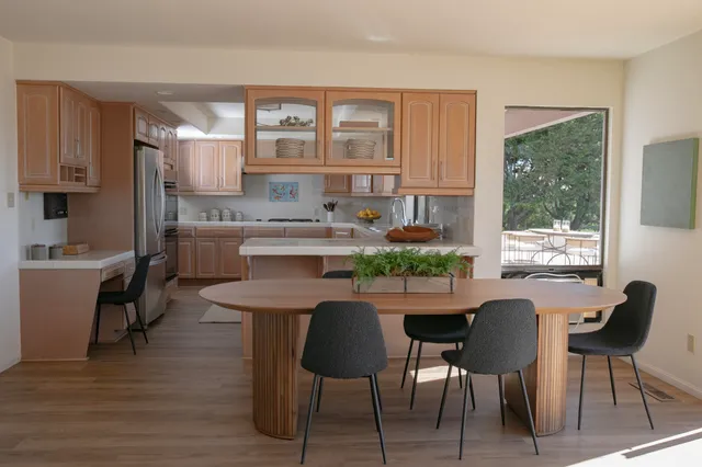a view of a dining room with furniture and a window
