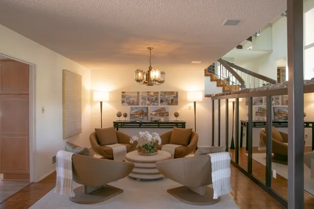 a dinning room with furniture and a chandelier