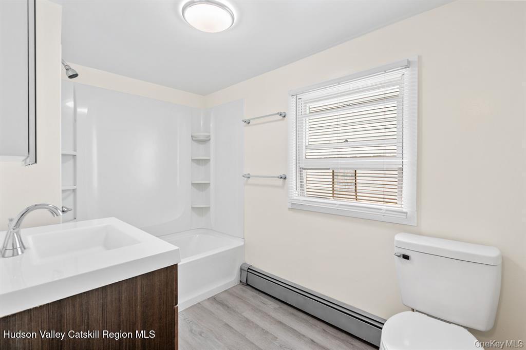 252-254 Partition Street Saugerties, NY 12477 - Photo 17 of 35 a bathroom with a sink mirror vanity and toilet