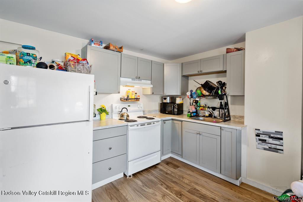 252-254 Partition Street Saugerties, NY 12477 - Photo 22 of 35 a white kitchen with a refrigerator and a sink