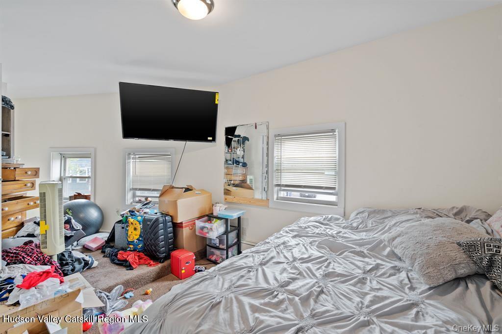 252-254 Partition Street Saugerties, NY 12477 - Photo 28 of 35 a bedroom with a bed furniture and a flat screen tv