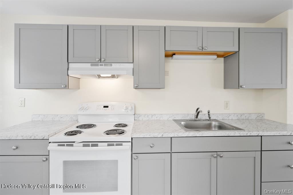 252-254 Partition Street Saugerties, NY 12477 - Photo 3 of 35 a kitchen with kitchen island a sink a stove and cabinets