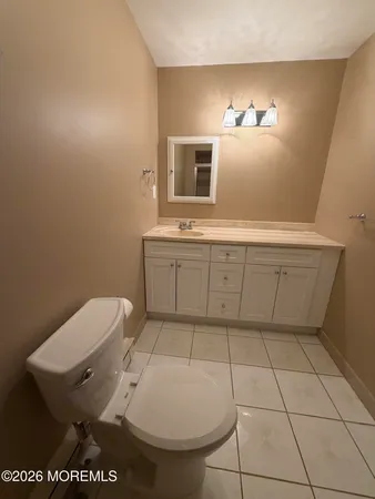a kitchen with a sink a stove top oven and cabinetry
