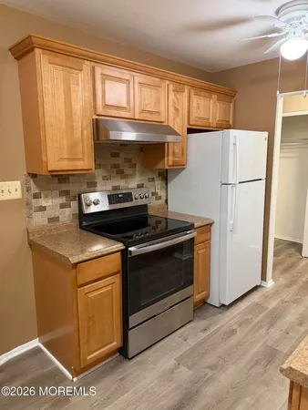 a kitchen with a stove a sink and a refrigerator