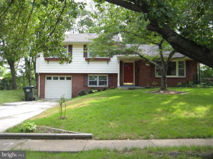 5218 Montgomery Street Springfield, VA 22151 - Photo 1 of 8 a front view of a house with a yard and garage
