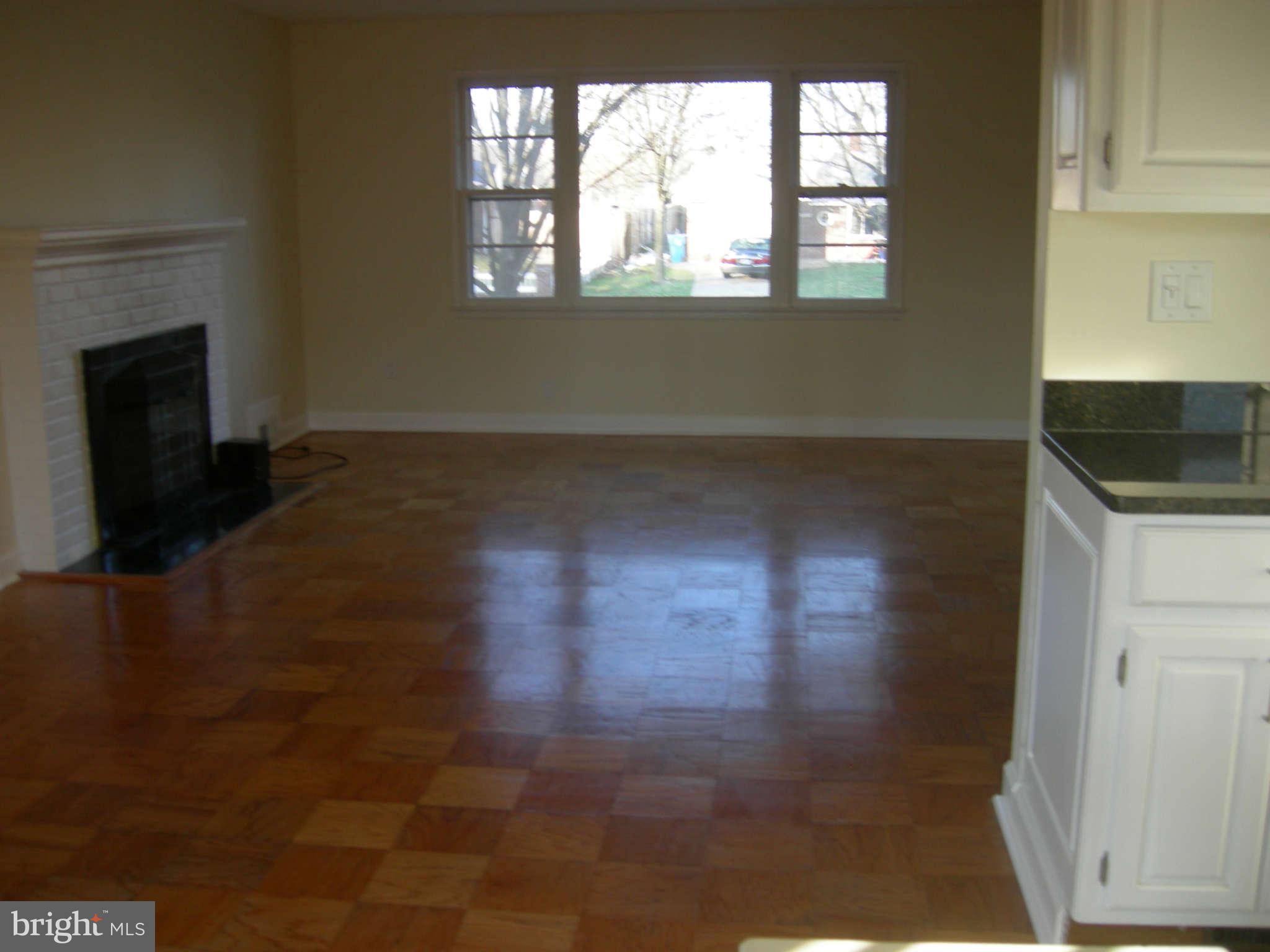 5218 Montgomery Street Springfield, VA 22151 - Photo 2 of 8 view of empty room with wooden floor and fan