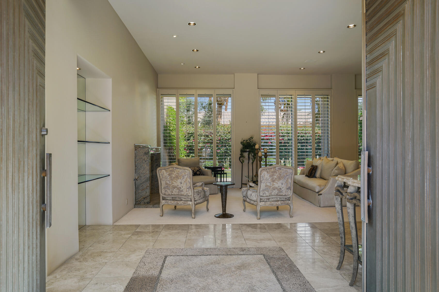 79140 Jack Rabbit Trail La Quinta, CA 92253 - Photo 19 of 61 a living room with fireplace furniture and floor to ceiling window