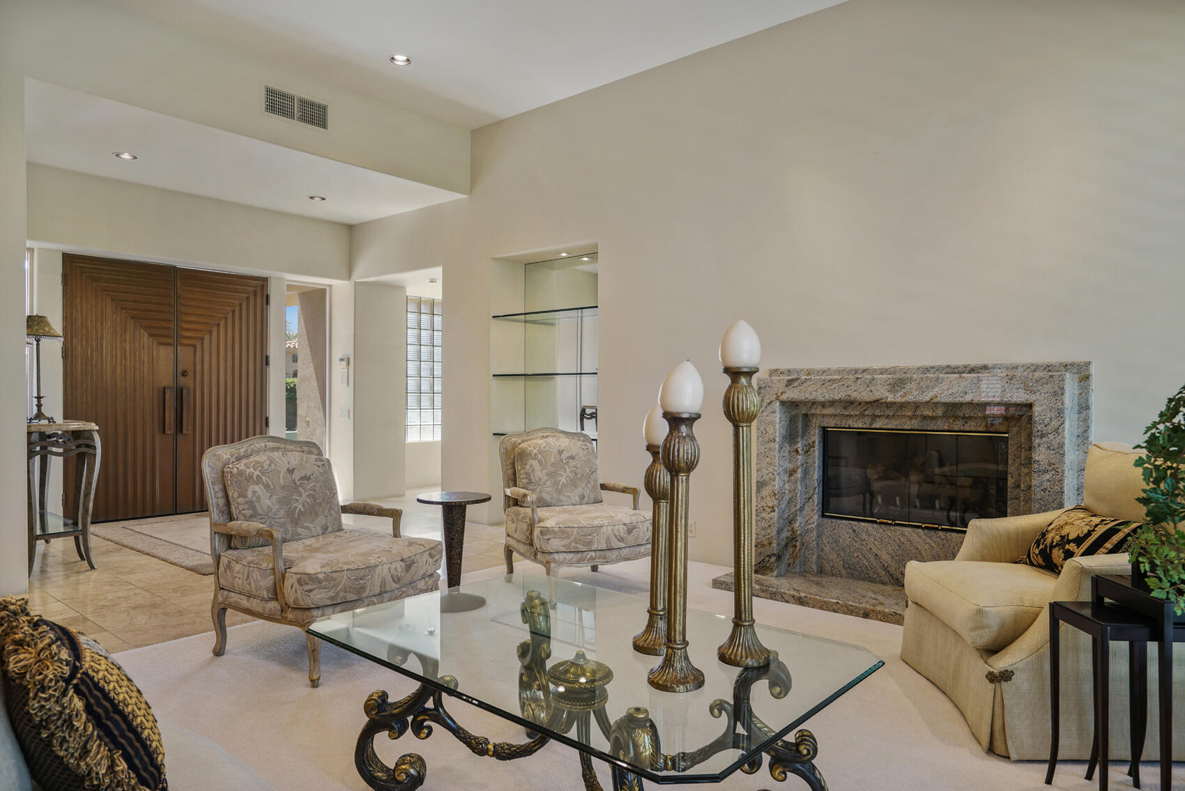 79140 Jack Rabbit Trail La Quinta, CA 92253 - Photo 22 of 61 a living room with furniture a fireplace and a table