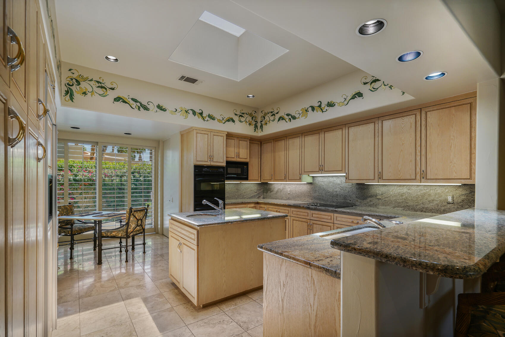 79140 Jack Rabbit Trail La Quinta, CA 92253 - Photo 32 of 61 a kitchen with a stove a refrigerator a sink and chairs