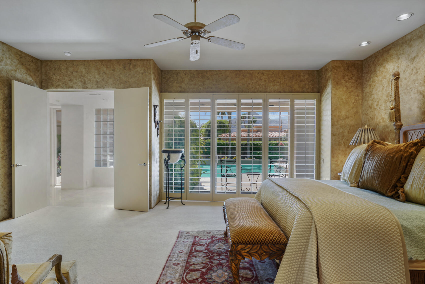 79140 Jack Rabbit Trail La Quinta, CA 92253 - Photo 38 of 61 a bedroom with a bed and glass walk in closet