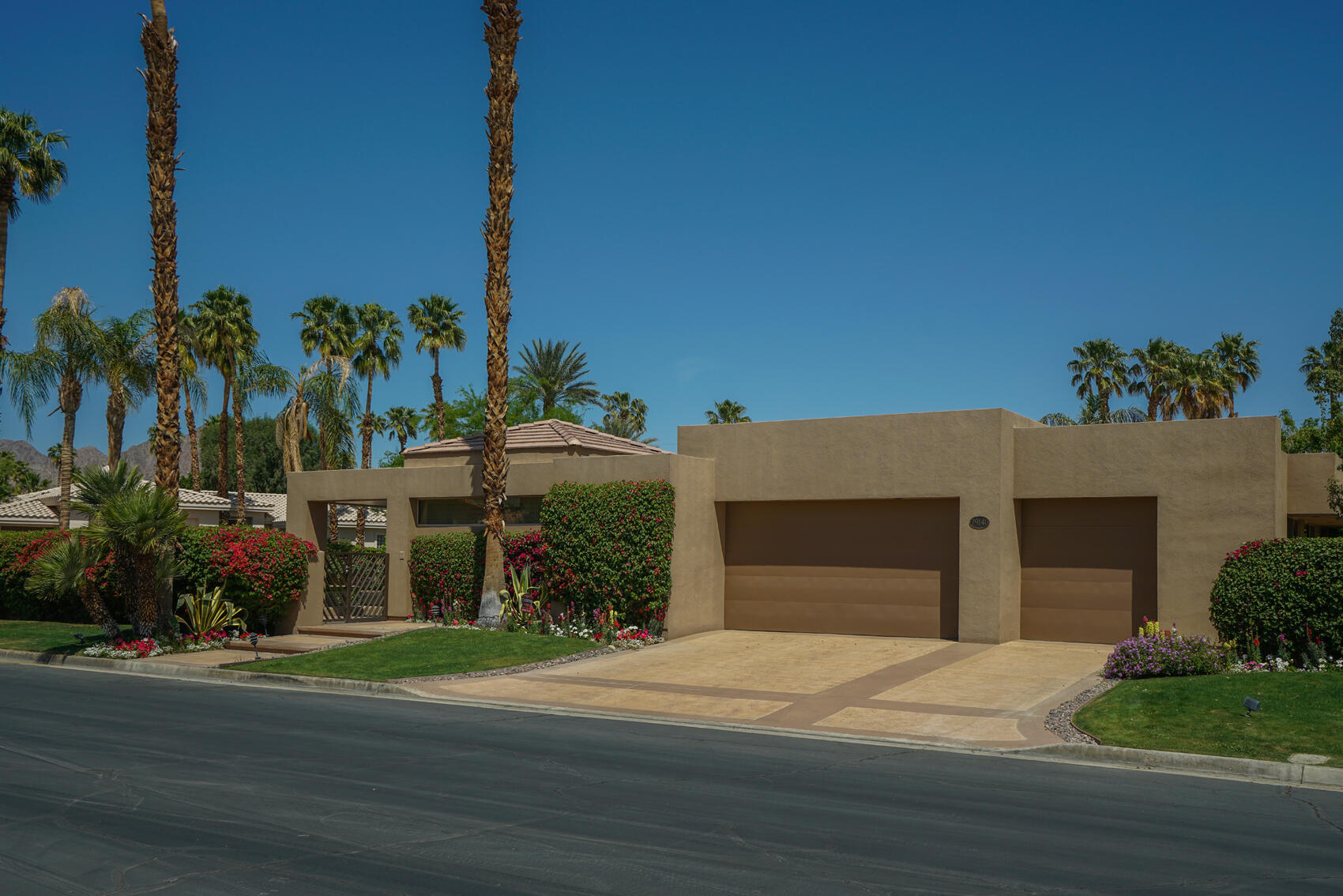 79140 Jack Rabbit Trail La Quinta, CA 92253 - Photo 4 of 61 a front view of a house with a yard and garage