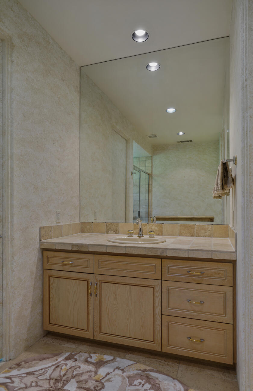79140 Jack Rabbit Trail La Quinta, CA 92253 - Photo 50 of 61 a bathroom with a granite countertop sink and a mirror