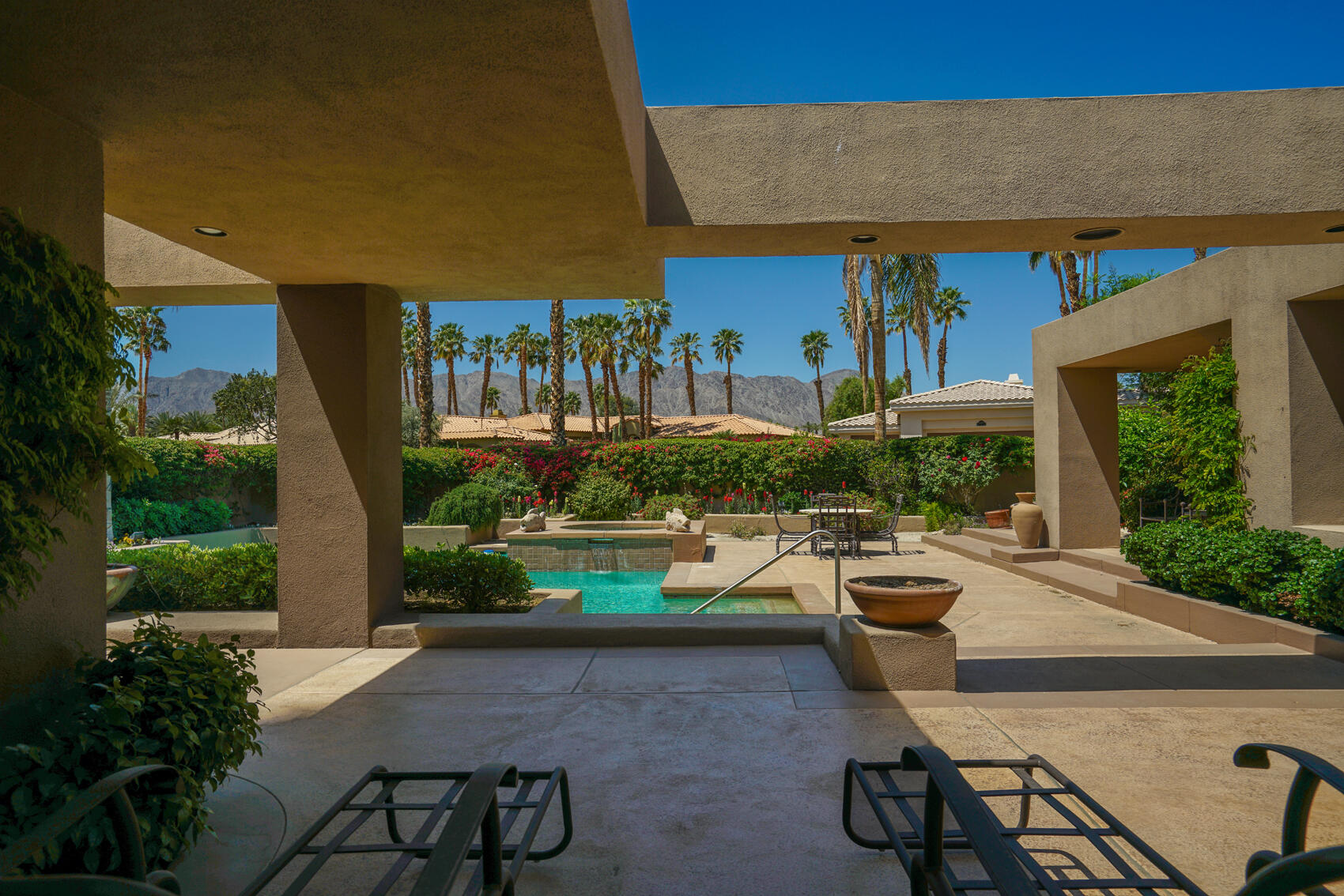 79140 Jack Rabbit Trail La Quinta, CA 92253 - Photo 7 of 61 a view of a patio with table and chairs potted plants