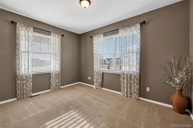 a living room with furniture and a book shelf