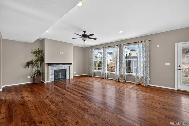 a kitchen with stainless steel appliances a dining table chairs a sink and a refrigerator