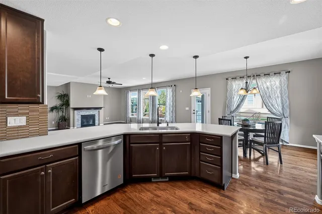 a kitchen with stainless steel appliances granite countertop wooden cabinets stove top oven and sink