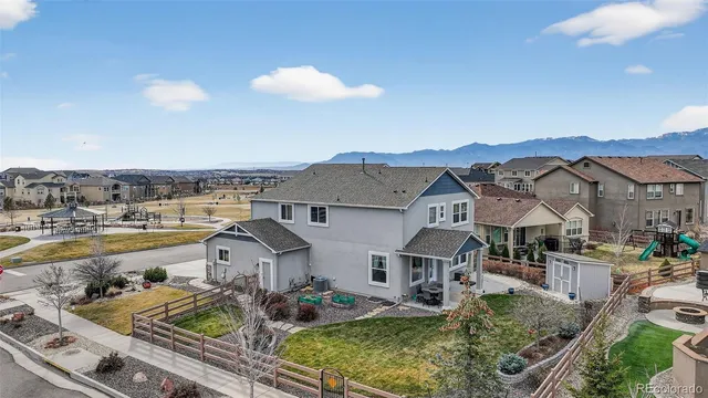 an aerial view of a house with swimming pool and ocean view