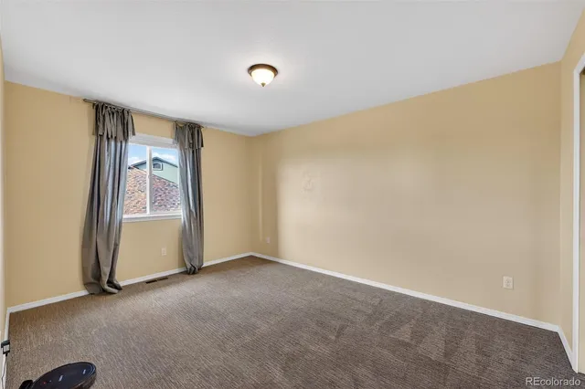 a view of a livingroom with a kitchen and a fireplace