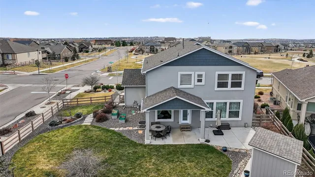 a aerial view of a house with table and chairs