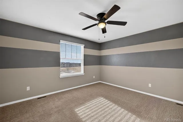 a kitchen with a stove and white cabinets