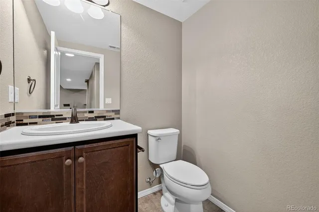 a bathroom with a sink a toilet a mirror a bathtub and shower