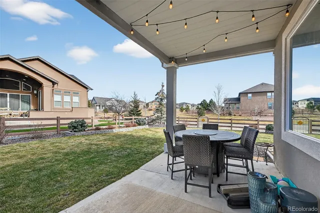 a view of a patio with table and chairs and potted plants