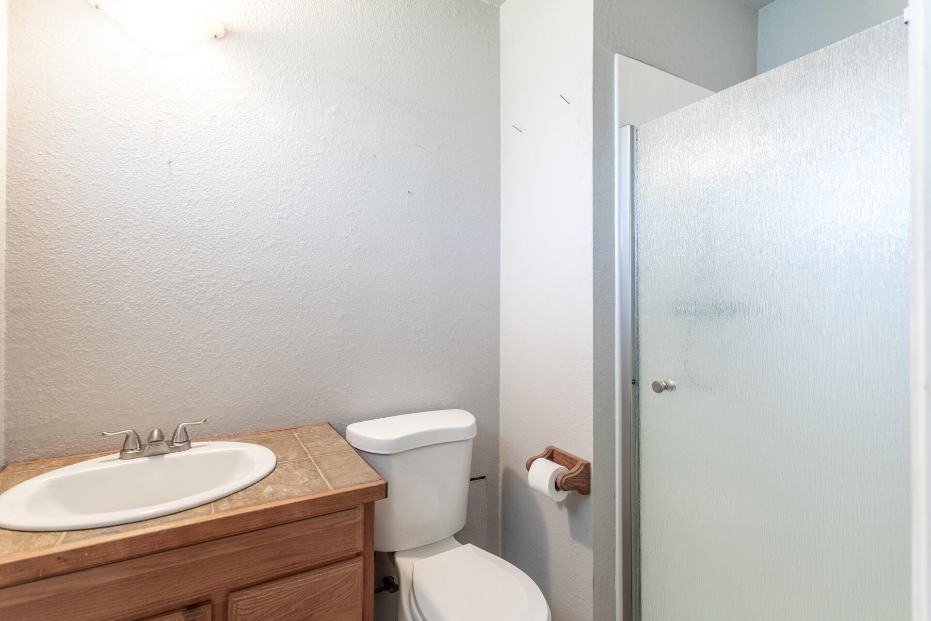 6874 Weeks Road Redding, CA 96002 - Photo 12 of 26 a bathroom with a toilet a sink and mirror