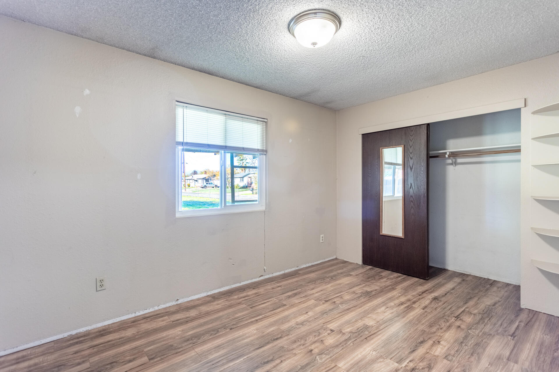 6874 Weeks Road Redding, CA 96002 - Photo 16 of 26 a view of empty room with wooden floor and fan