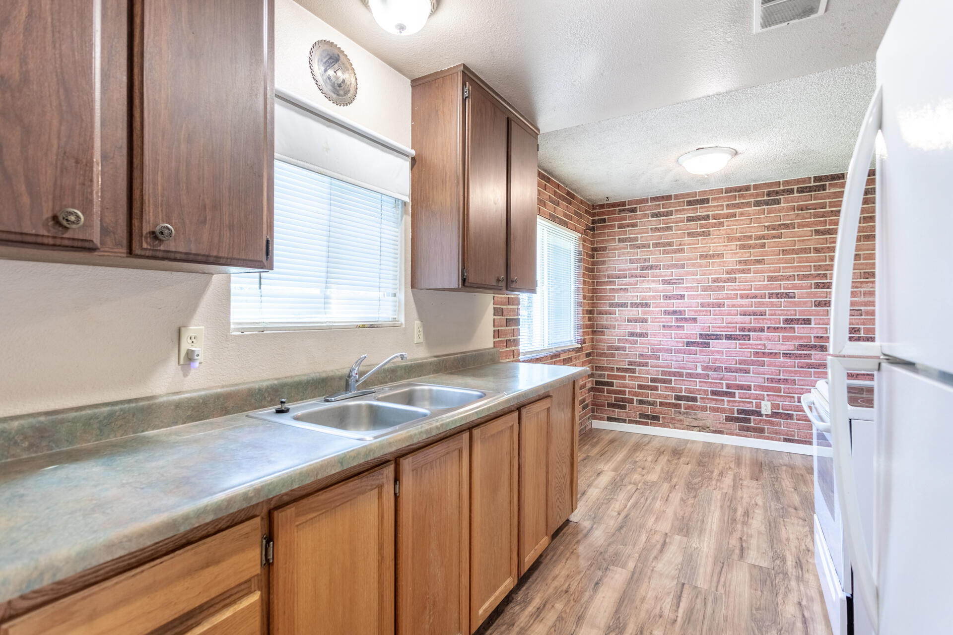 6874 Weeks Road Redding, CA 96002 - Photo 7 of 26 a kitchen with granite countertop a sink and cabinets
