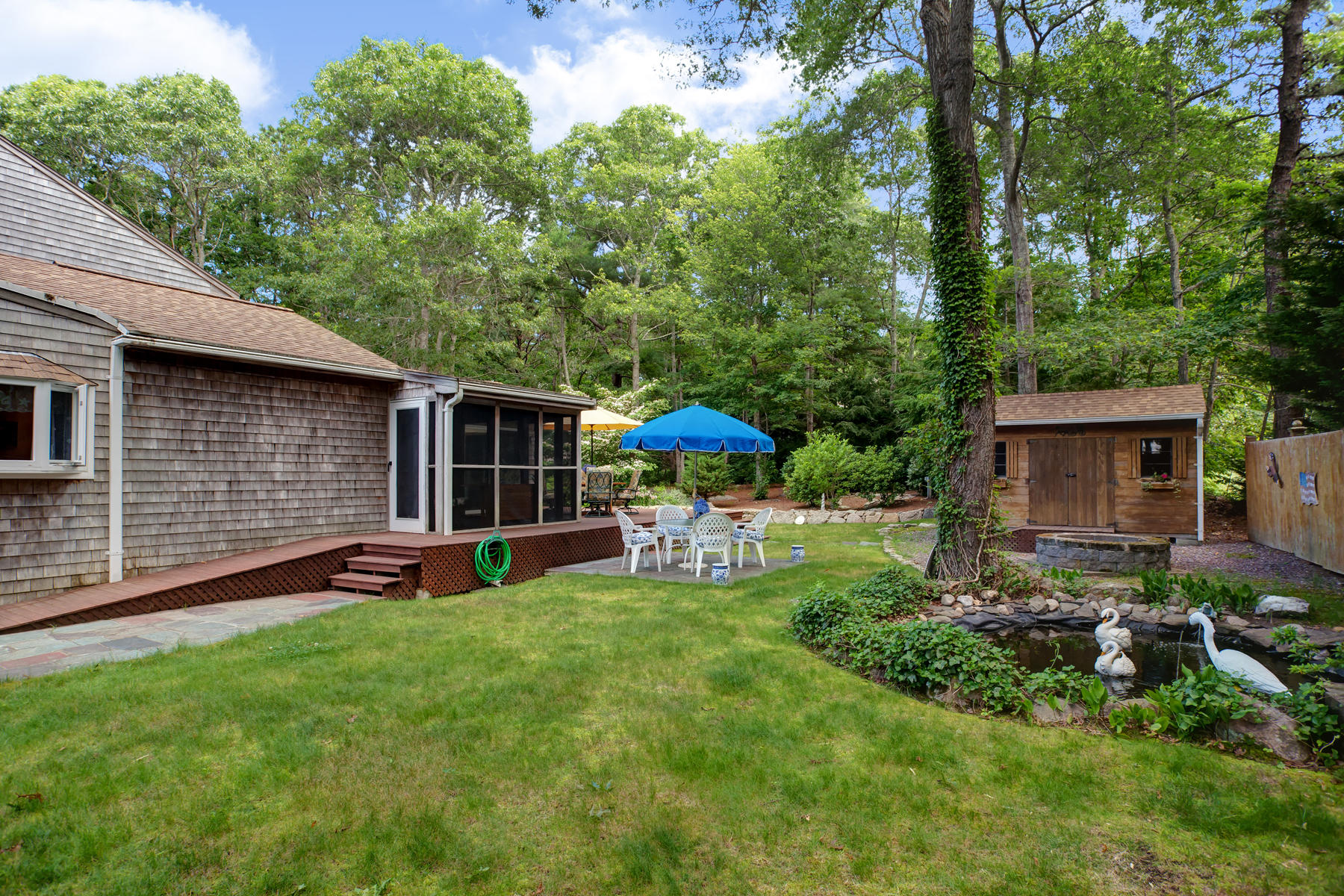 18 Frederick Road Falmouth, MA 02540 - Photo 35 of 62 a view of a house with backyard sitting area and garden