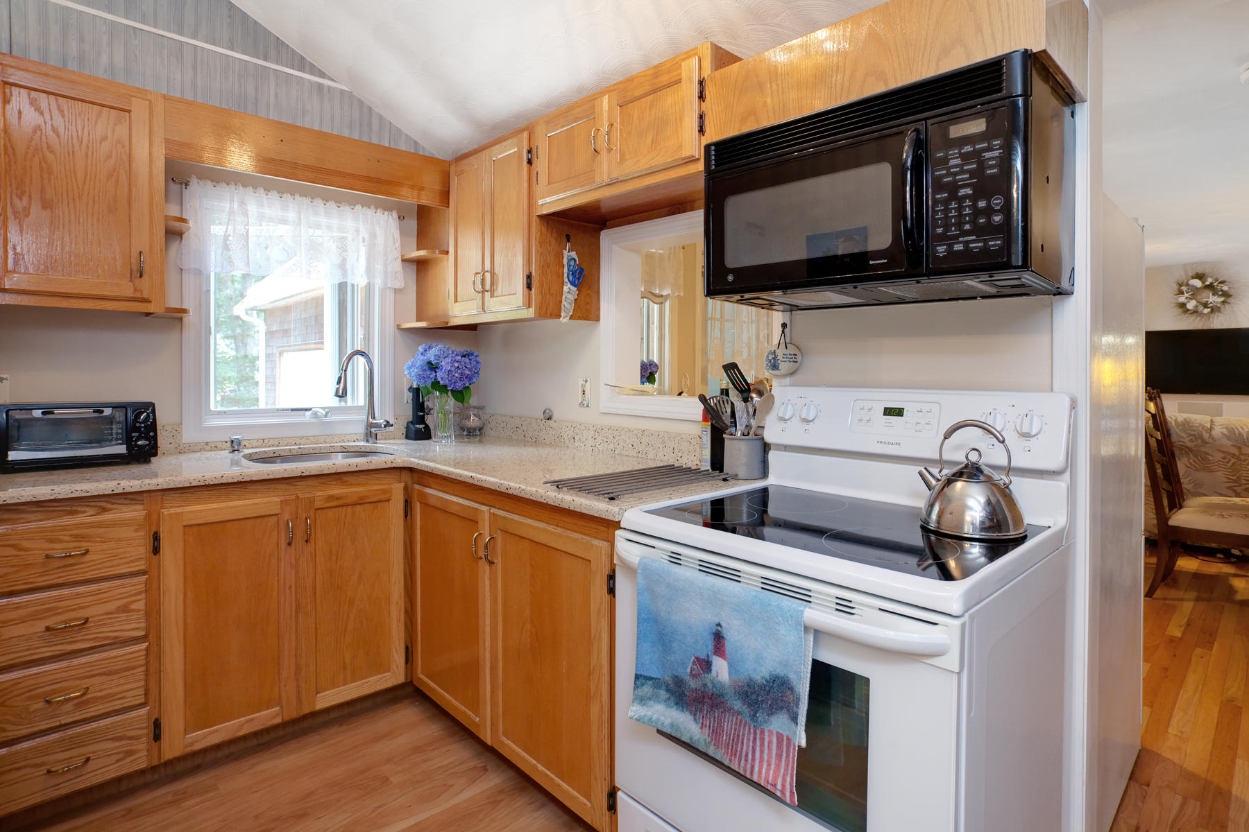 18 Frederick Road Falmouth, MA 02540 - Photo 41 of 62 a kitchen with stainless steel appliances granite countertop a stove a sink and a microwave