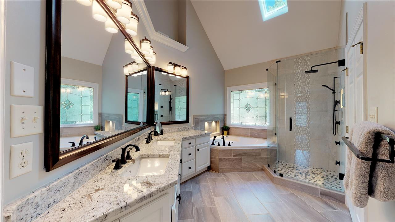 3132 Cranesbill Drive Raleigh, NC 27613 - Photo 23 of 30 A unique luxurious master bath awaits you. Whether it's a quick morning shower or an evening soak in the whirlpool tub, you will enjoy your time spent in this room. The double vanity assures that everyone will be ready on time. Master Bath/Spa