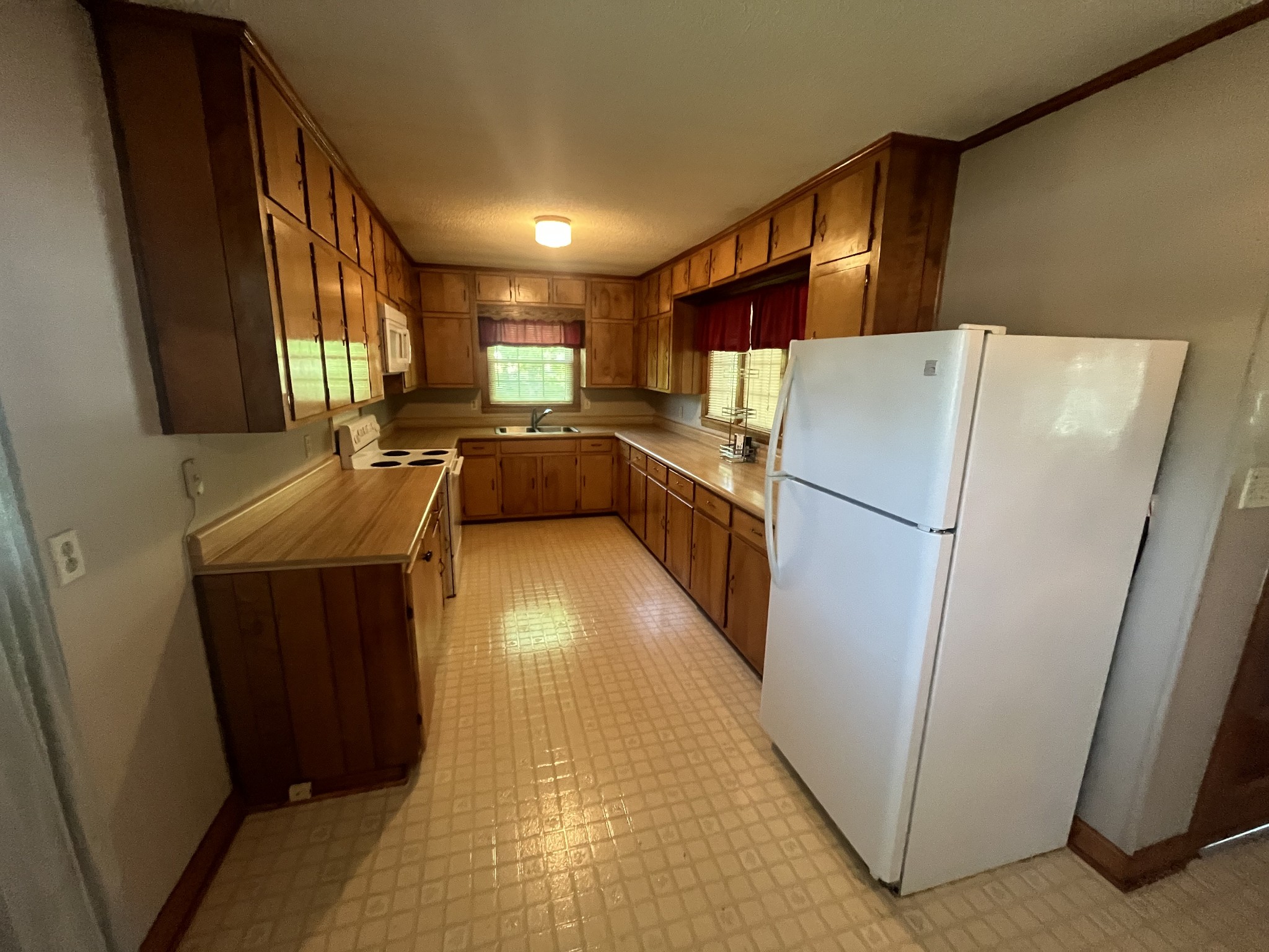 1619 Railroad Bed Road Collinwood, TN 38450 - Photo 11 of 54 a kitchen with a refrigerator a stove top oven a sink and dishwasher
