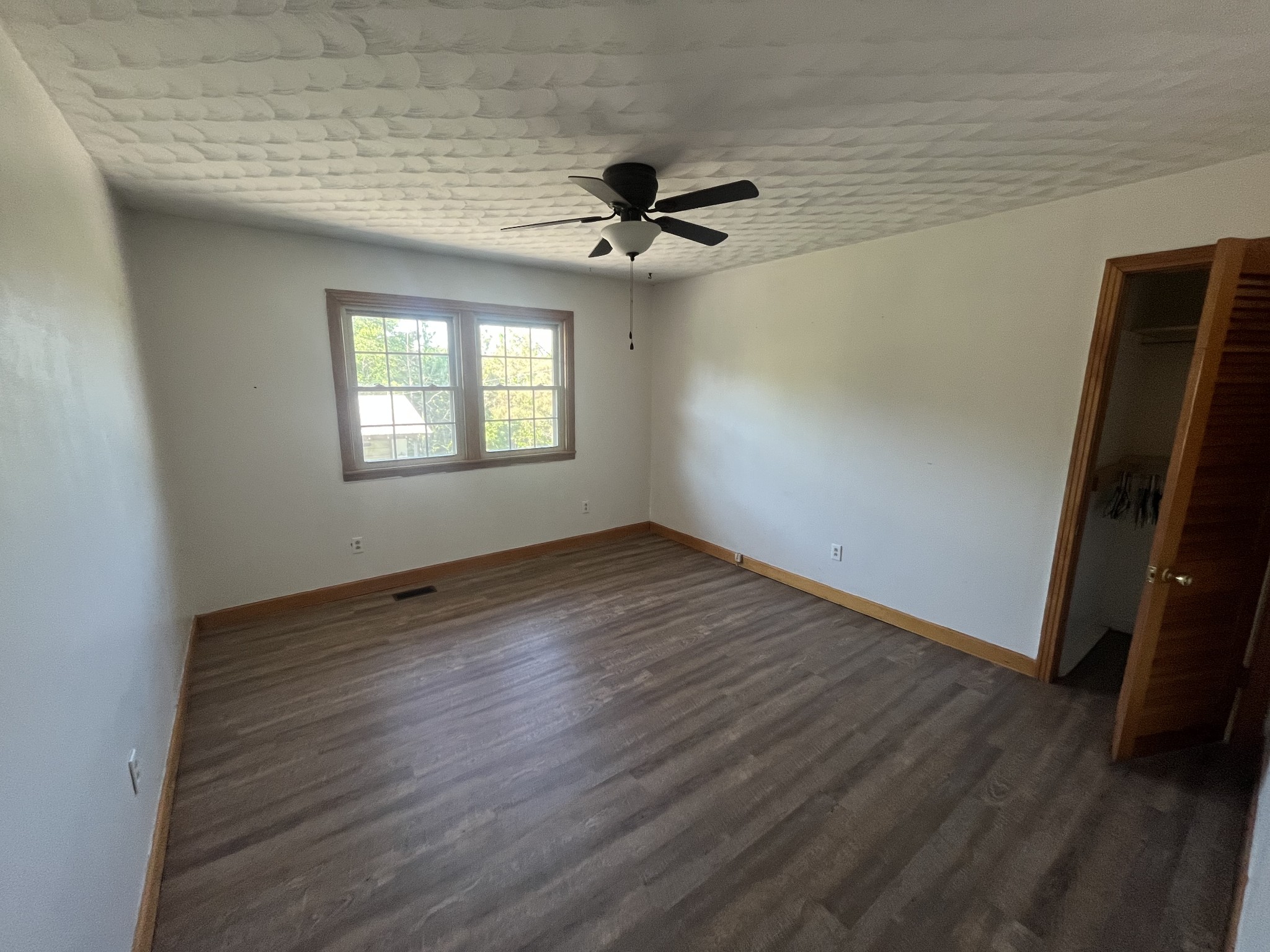 1619 Railroad Bed Road Collinwood, TN 38450 - Photo 18 of 54 an empty room with wooden floor and windows