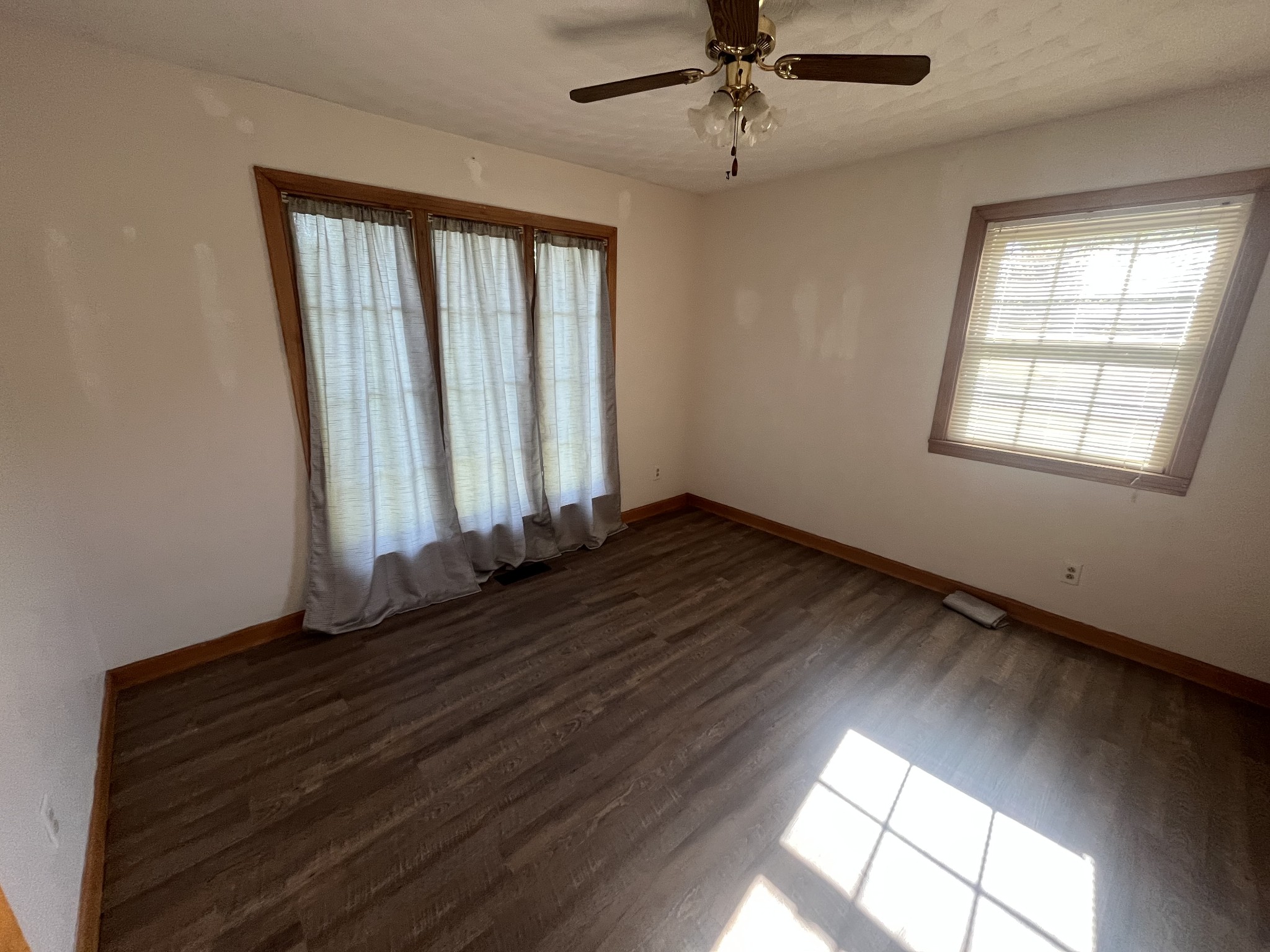 1619 Railroad Bed Road Collinwood, TN 38450 - Photo 20 of 54 an empty room with wooden floor fan and windows