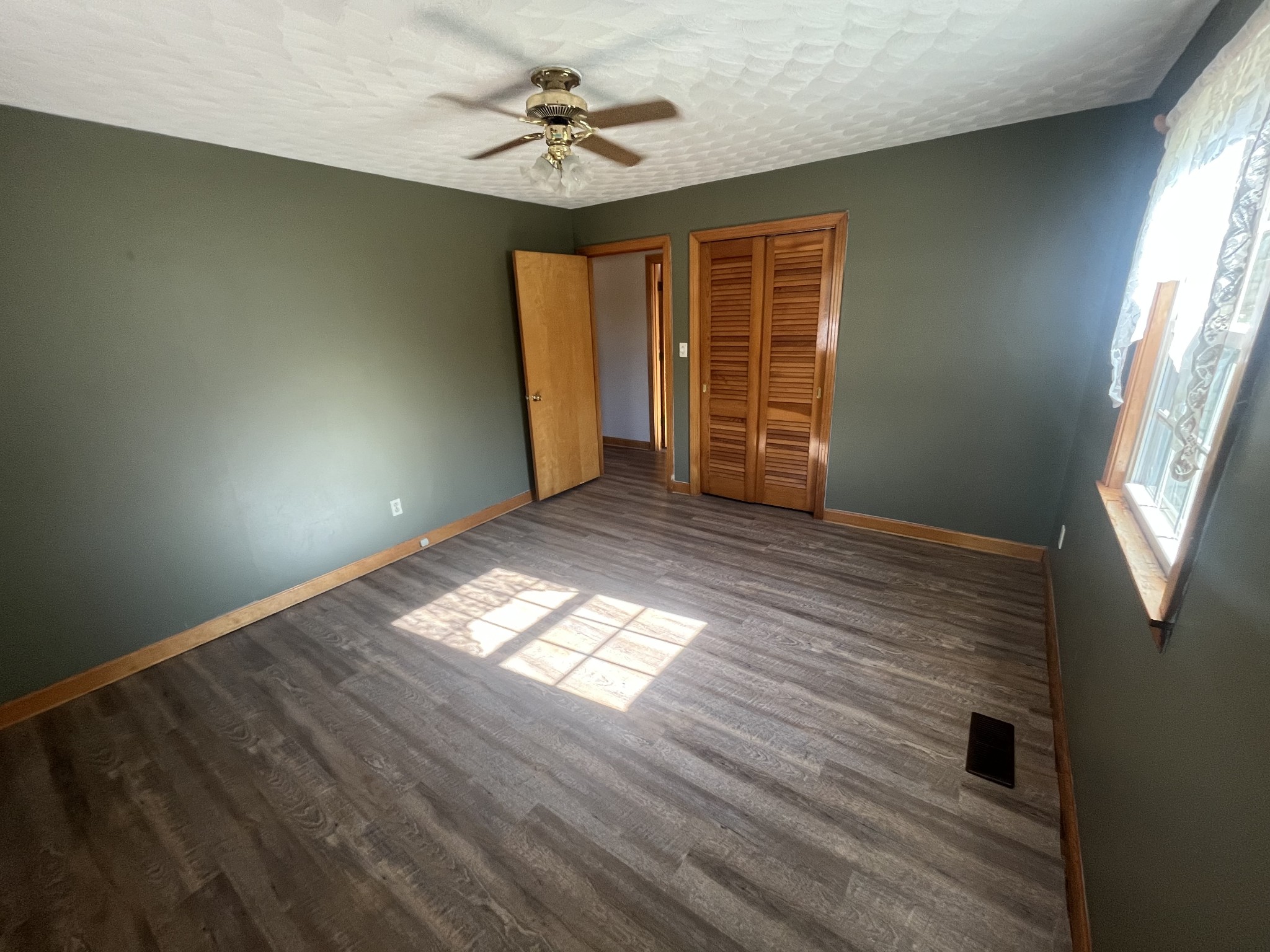 1619 Railroad Bed Road Collinwood, TN 38450 - Photo 23 of 54 a view of empty room with wooden floor and fan