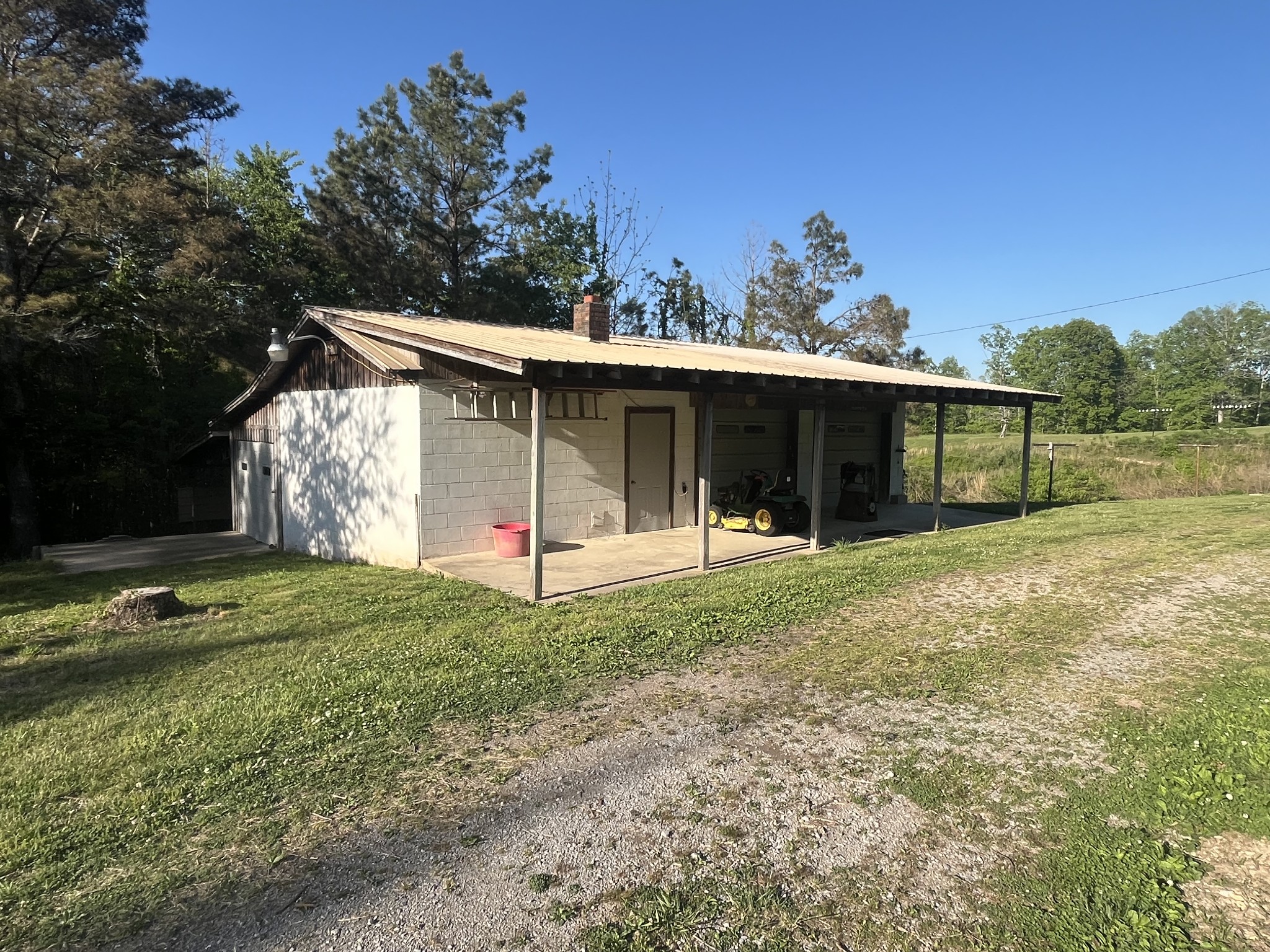 1619 Railroad Bed Road Collinwood, TN 38450 - Photo 41 of 54 a front view of a house with a yard and garage