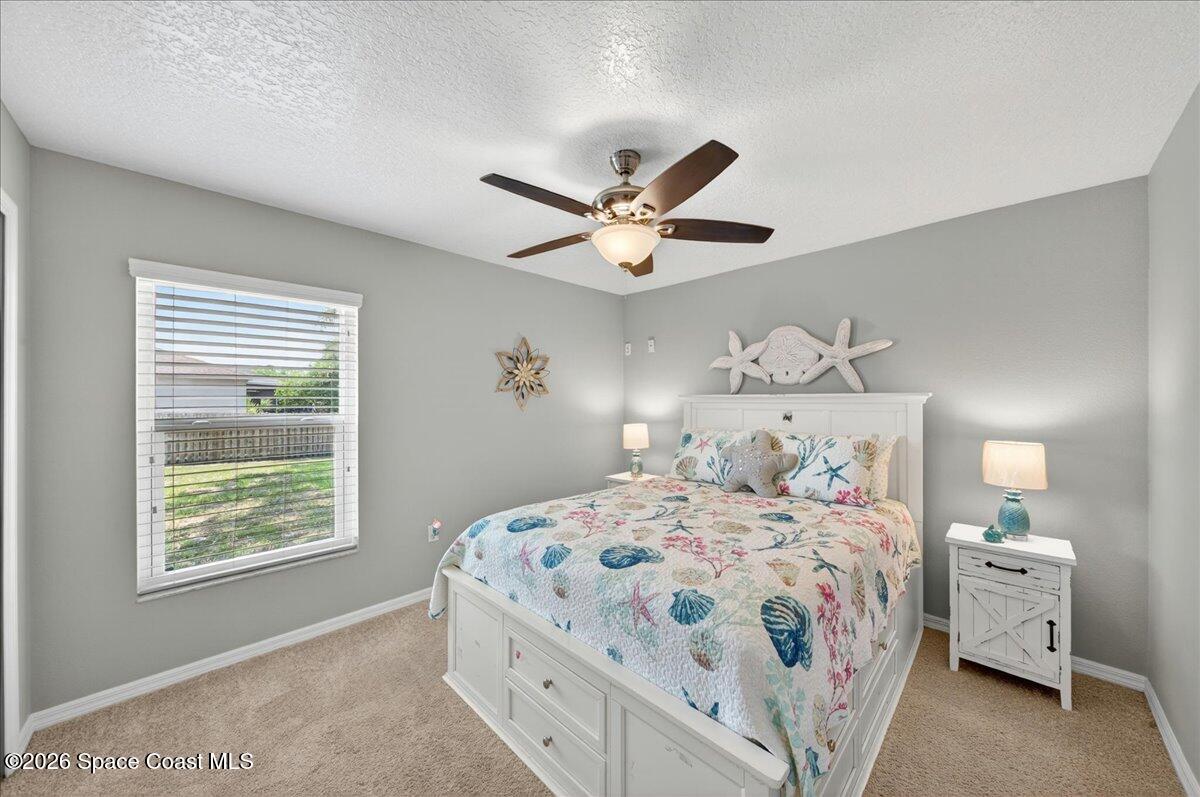 5975 Aruin Street Cocoa, FL 32927 - Photo 25 of 70 a bedroom with a bed and a chandelier