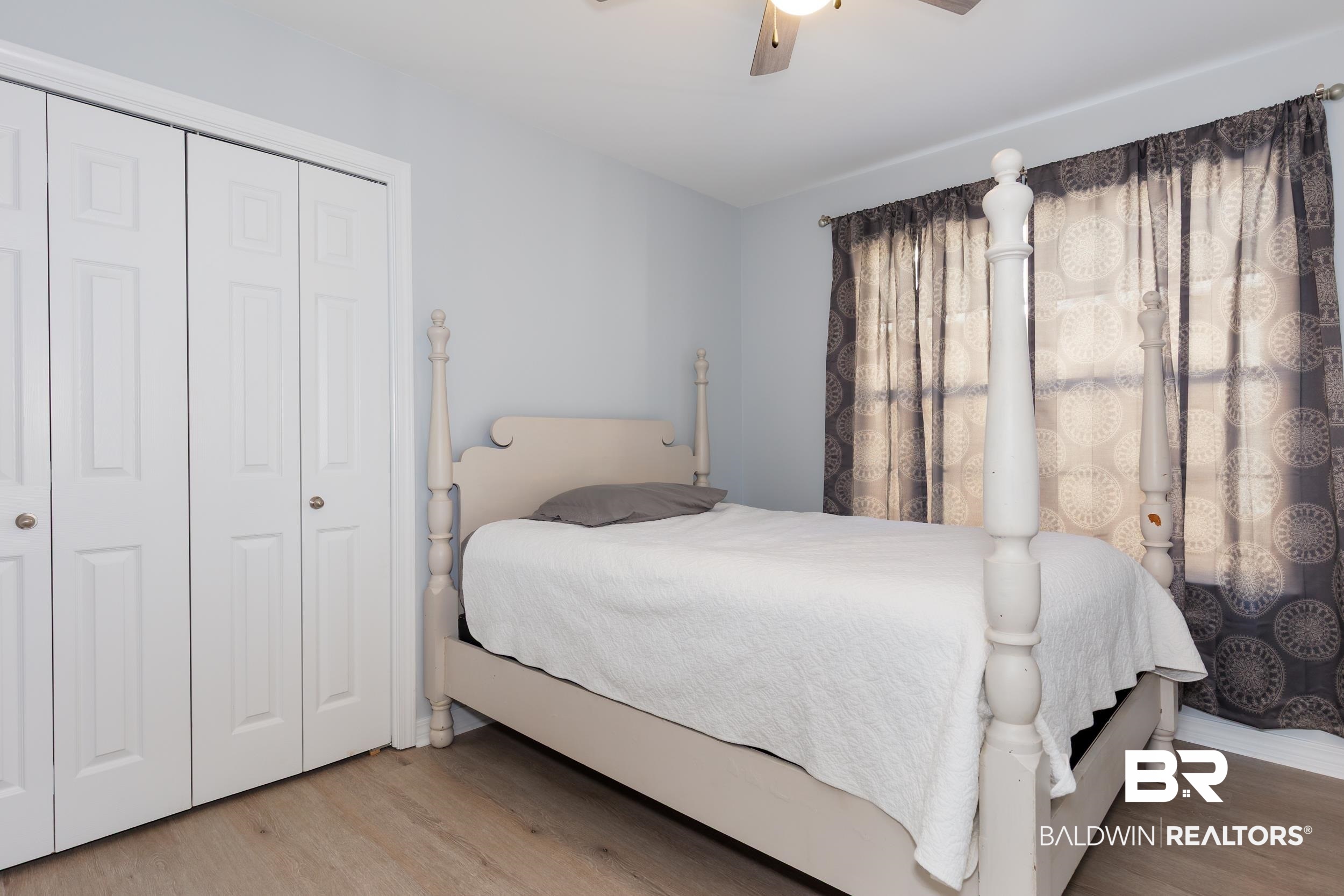 16227 Zenith Drive Loxley, AL 36551 - Photo 18 of 23 Bedroom featuring a closet, a ceiling fan, and wood finished floors