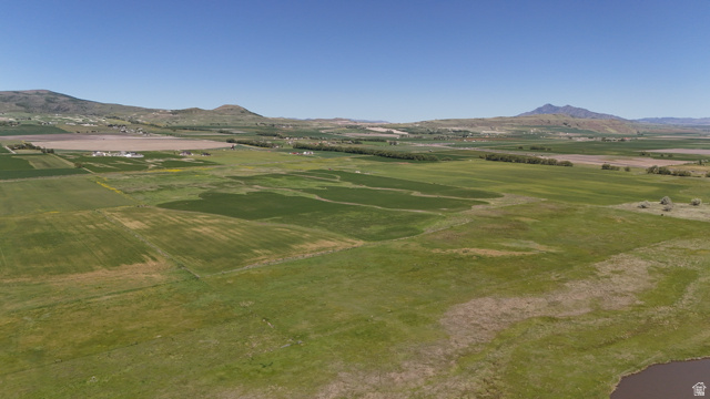 320 South 5400 West Logan, UT 84321 - Photo 18 of 42 Expansive land parcel featuring open fields and distant mountain ranges under a clear sky