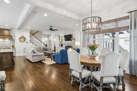 a view of a dining room with furniture a chandelier and wooden floor